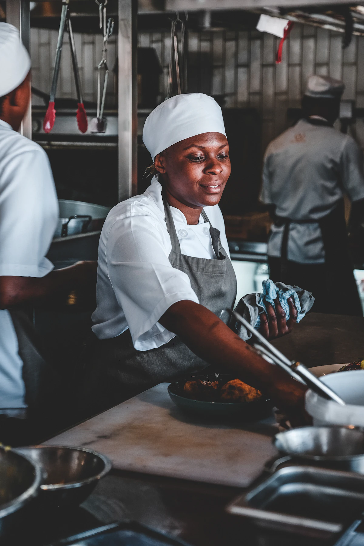 Une cuisinière souriante dans sa cuisine